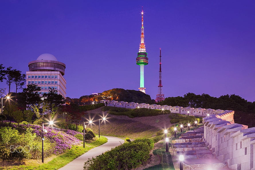 N Seoul Tower and Namsan Park at Dusk with Illuminated Skyline and Garden Path HD wallpaper