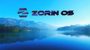 Zorin OS Logo Over Serene Mountain Lake Landscape With Blue Sky And Forested Hills HD wallpaper