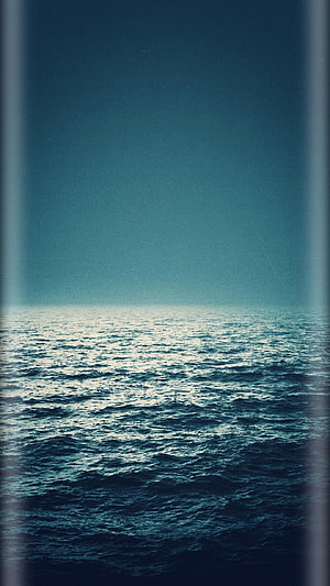 Serene Ocean Horizon Under a Gradient Teal Sky with Soft Light Reflections HD phone wallpaper