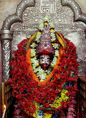 Maa Tara Deity Adorned With Vibrant Flower Garlands In Ornate Silver Shrine HD phone wallpaper
