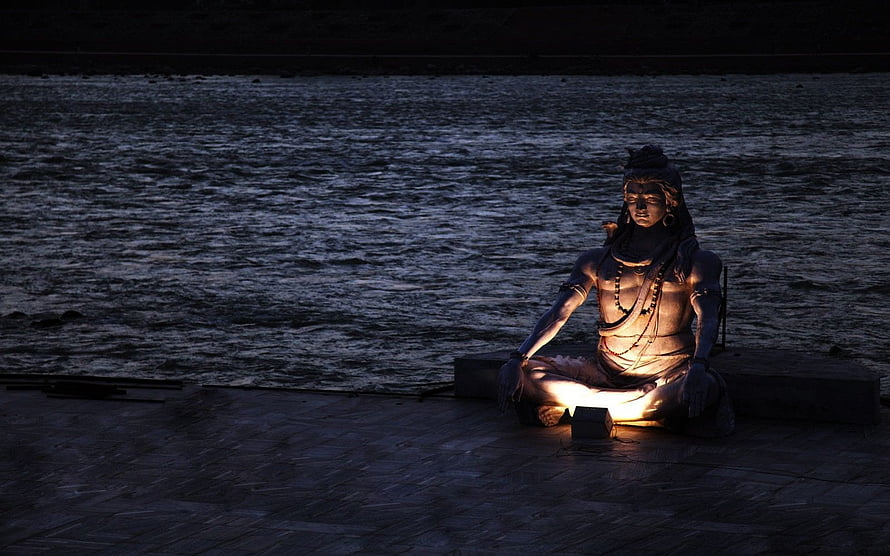 Illuminated Mahadev Statue Meditating by the River at Night HD wallpaper