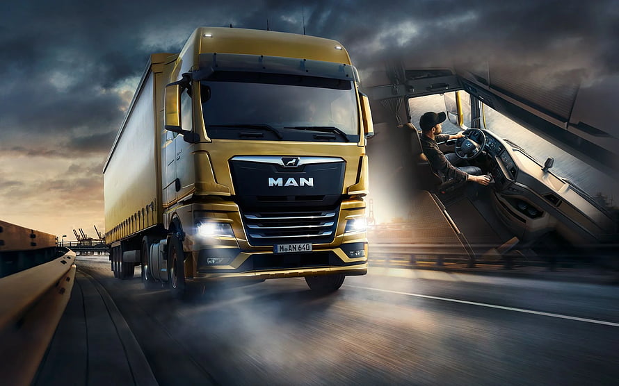 Gold MAN TGX Heavy-Duty Truck Driving on Highway at Dusk with Dramatic Sky HD wallpaper