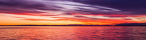 Vivid Sunset Over Calm Ocean Waters With Dramatic Clouds HD wallpaper