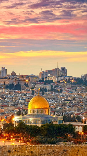 Dome of the Rock in Jerusalem at sunset with vibrant pink and orange sky over the Old City skyline HD phone wallpaper