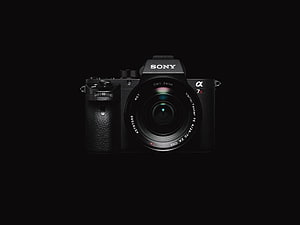 Sony Alpha 7R II Mirrorless Camera with Carl Zeiss Vario-Tessar Lens on Black Background HD wallpaper