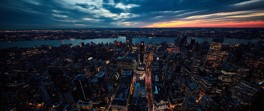 Aerial View of New York City Skyline at Dusk with Dramatic Sunset Clouds HD wallpaper