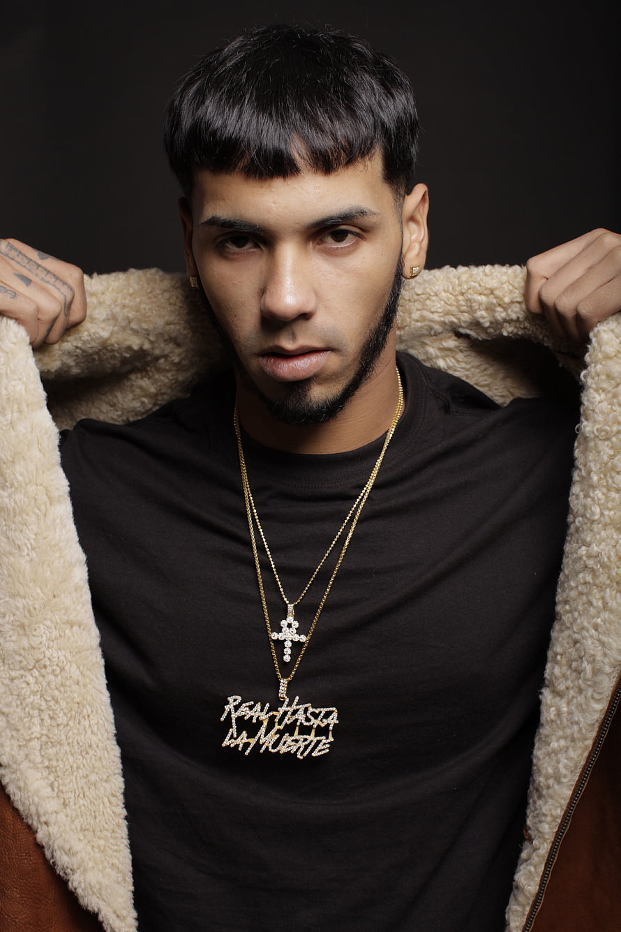 Deza Portrait in Black Tee and Shearling Jacket with Gold Cross Necklace HD phone wallpaper