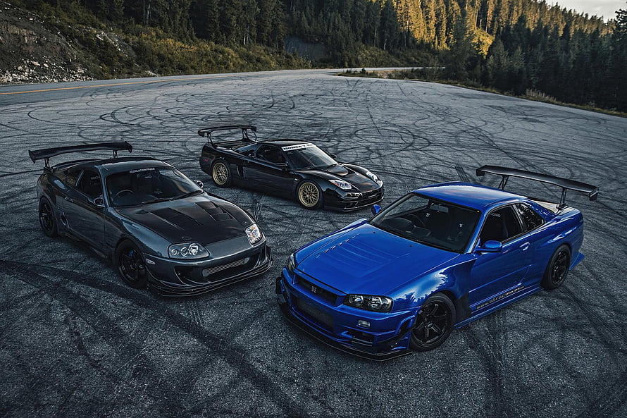 Three JDM Supercars: Toyota Supra, Acura NSX, and Nissan R34 GT-R on a Mountain Road HD wallpaper