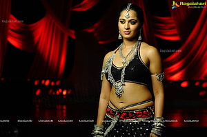 Anushka Shetty in Traditional Indian Dance Attire with Silver Jewelry and Red Stage Backdrop HD wallpaper