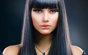 Close-up portrait of a woman with long straight black hair and blunt bangs against a dark background HD wallpaper
