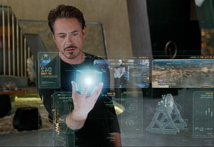 Tony Stark Interacting with Holographic Interface in Iron Man HD wallpaper