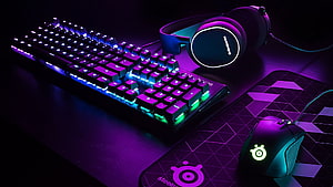 SteelSeries RGB Gaming Setup with Mechanical Keyboard, Mouse, and Headset in Purple and Blue Neon Lighting HD wallpaper