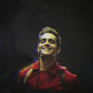 Money Heist Character in Red Jacket Smiling Against Dark Brick Wall HD phone wallpaper