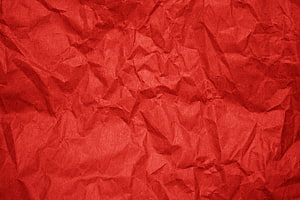 Crimson Crumpled Paper Texture with Deep Folds and Organic Surface Detail HD wallpaper