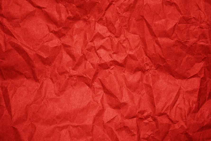 Crimson Crumpled Paper Texture with Deep Folds and Organic Surface Detail HD wallpaper
