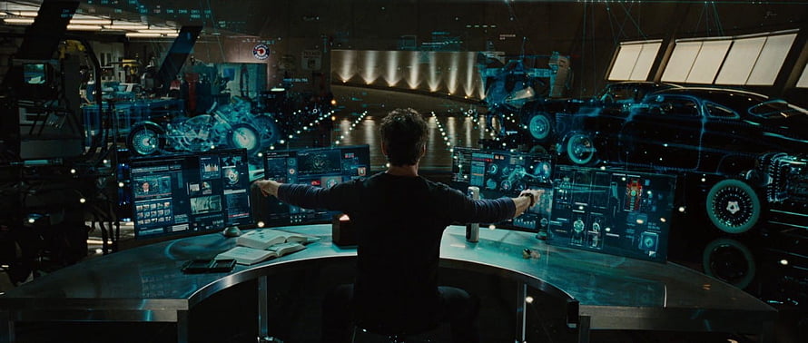 Tony Stark in the Iron Man Lab with Holographic Vehicle Schematics HD wallpaper