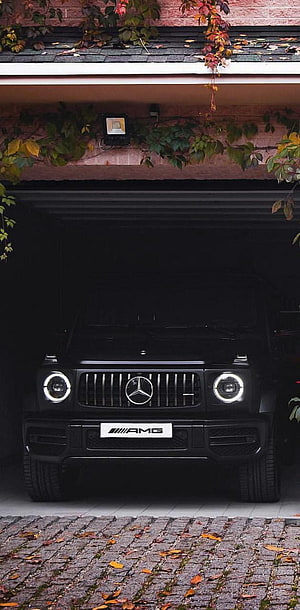 Black Mercedes-AMG G-Class SUV Front View in Garage with Autumn Foliage HD phone wallpaper
