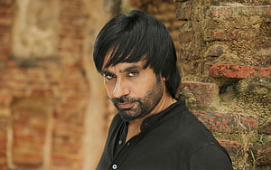 Babbu Maan Portrait Against Weathered Brick Wall in Black Shirt HD wallpaper