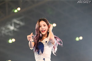 Wonyoung of IVE performing on stage in a white sailor outfit with purple hair HD wallpaper