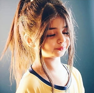 Cute young girl with a high ponytail and soft golden lighting HD wallpaper