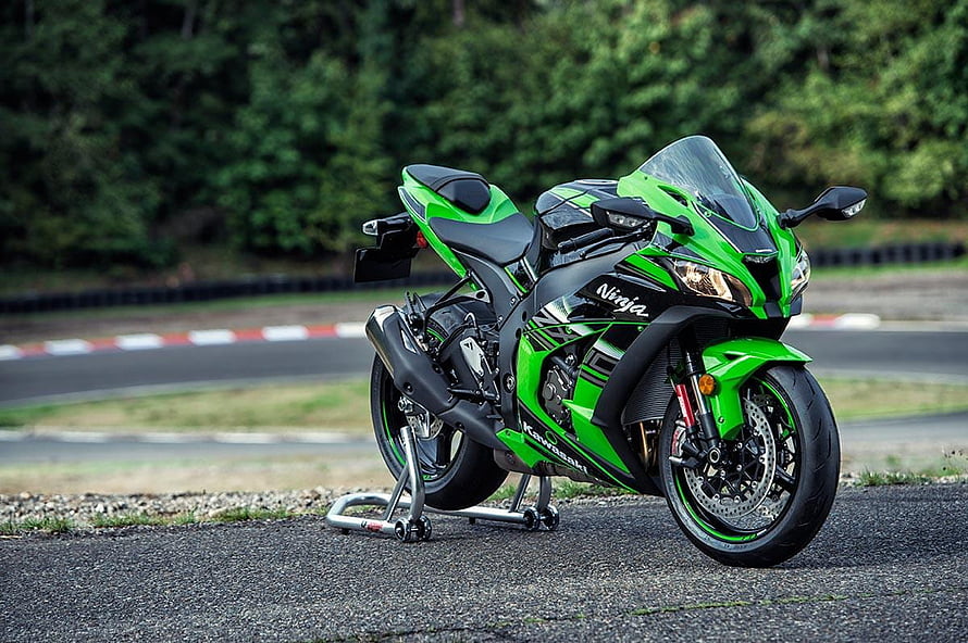 Kawasaki Ninja ZX-10R sportbike in green and black parked on a racetrack HD wallpaper
