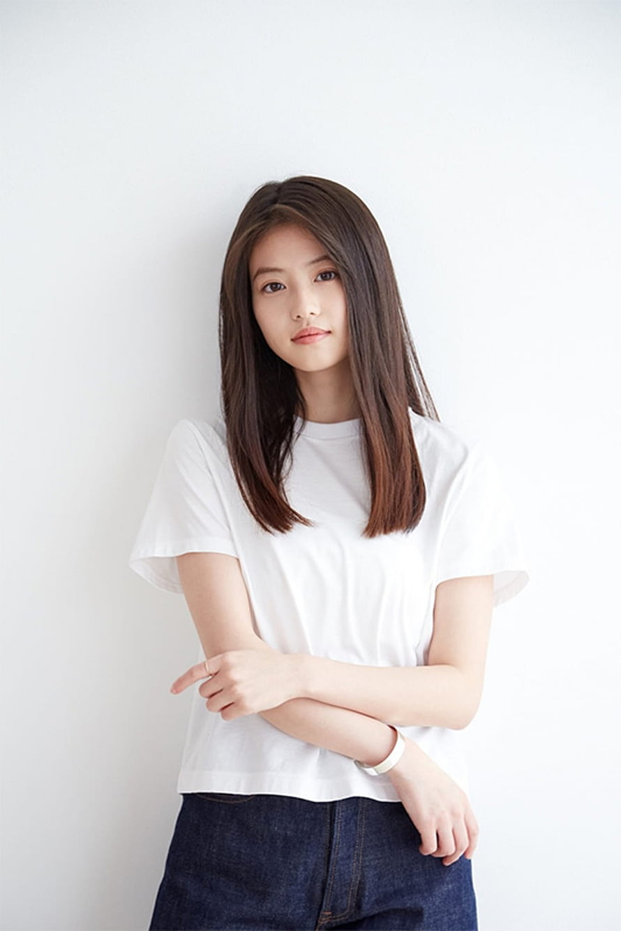 Imada Mio in a White T-Shirt and Denim Skirt Against a Minimalist White Background HD phone wallpaper