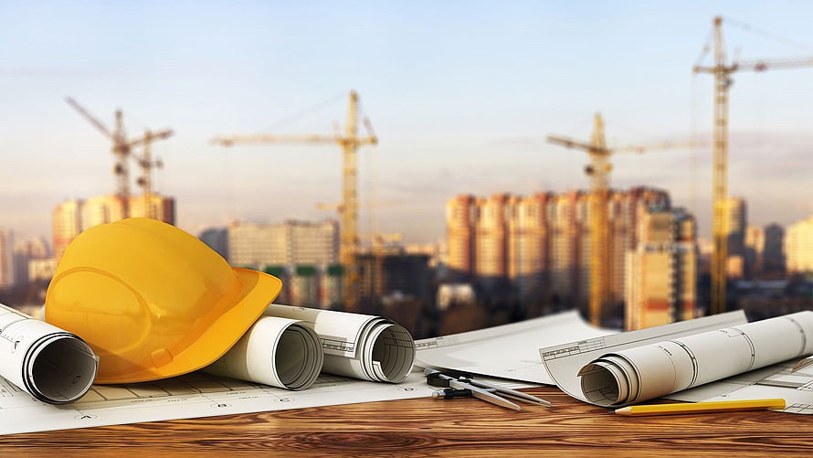 Construction Site Planning with Hard Hat and Blueprints Against Urban Skyline HD wallpaper