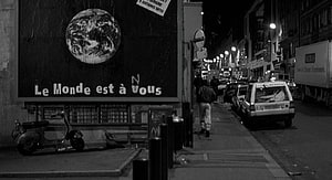La Haine Nighttime Paris Street Scene with Earth Billboard and Parked Scooter HD wallpaper