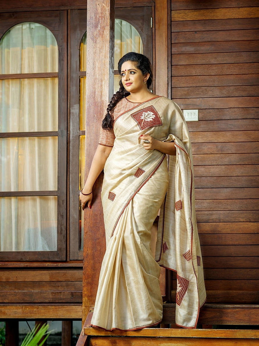 Kavya Madhavan in a Traditional Kerala Saree with Intricate Red Motifs HD phone wallpaper