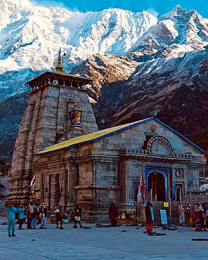 Kedarnath Temple with Snow-Capped Himalayan Peaks and Pilgrims in the Foreground HD phone wallpaper