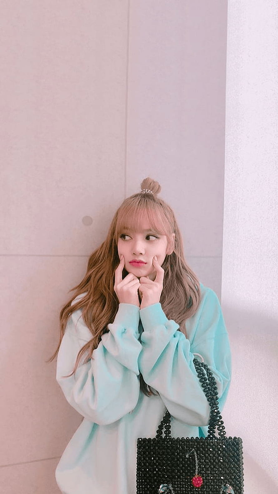 Lisa from Blackpink in a pastel mint oversized sweater with a beaded black handbag HD phone wallpaper