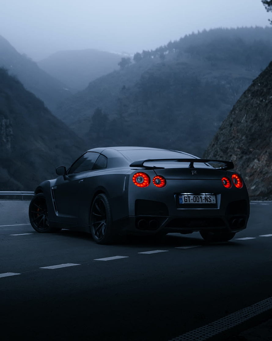 Nissan GT-R R35 Rear View on a Misty Mountain Road at Dusk HD phone wallpaper