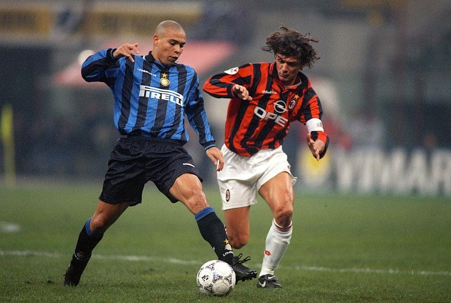 Ronaldo Nazario in Inter Milan kit battling AC Milan player on wet pitch HD wallpaper