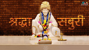 Sai Baba Statue Seated in White Garments with Flower Garland and Oil Lamp HD wallpaper