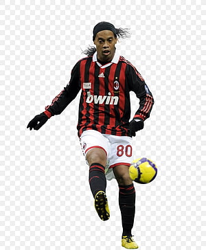 Ronaldinho in AC Milan red and black striped kit kicking a football HD phone wallpaper