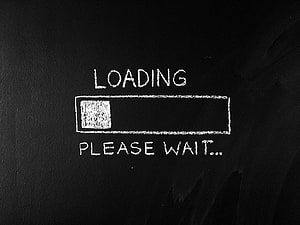 Hand-drawn loading progress bar with please wait text on a dark chalkboard background HD wallpaper