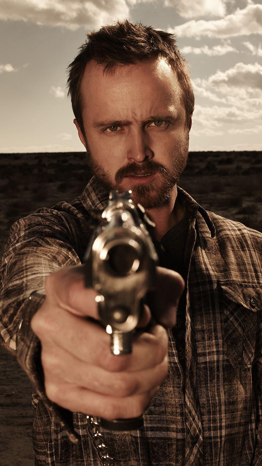 Jesse Pinkman from Breaking Bad aiming a revolver in a tense desert standoff HD phone wallpaper