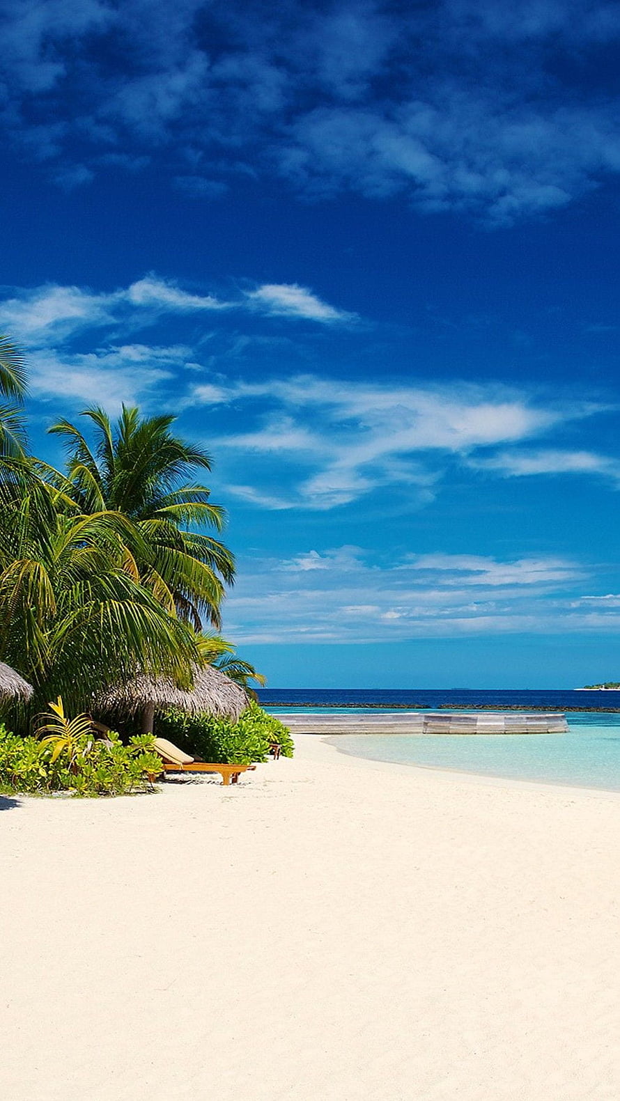 Tropical Beach Scene With Palm Trees, Thatched Huts, and Turquoise Ocean Waters Under a Bright Blue Sky HD phone wallpaper