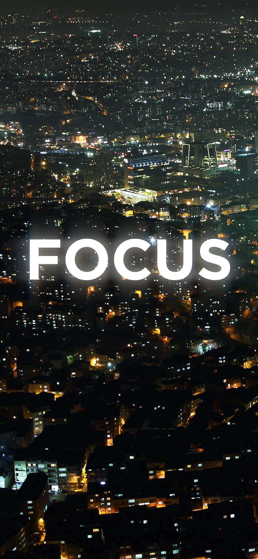 Aerial Night View of a Glowing Cityscape with the Word Focus in White Text HD phone wallpaper
