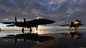 Silhouetted Indian Air Force fighter jets on a wet tarmac at sunset with dramatic cloud reflections HD wallpaper