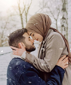 Muslim couple embracing in snowfall, woman wearing hijab and man with beard in winter forest, 100 Muslim Couple trending, hijab couple HD phone wallpaper