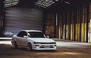 White Toyota Corolla AE100 Sedan Parked in Industrial Warehouse HD wallpaper