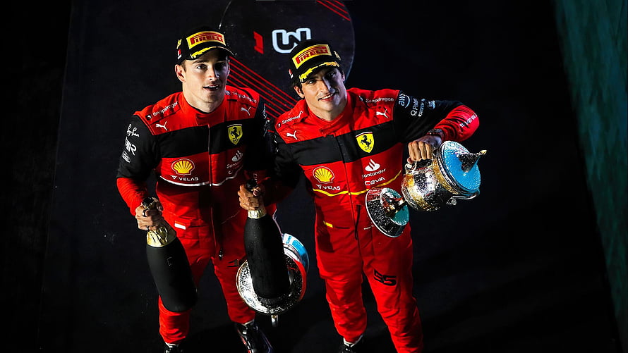 Charles Leclerc and Carlos Sainz Jr. Celebrate Victory in Ferrari Racing Suits HD wallpaper