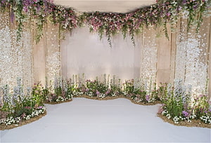 Romantic Wedding Ceremony Backdrop with Lush Floral Arrangements and Draped Greenery HD wallpaper