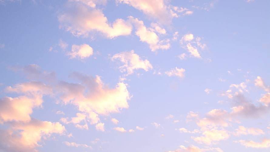 Soft Pastel Sky with Fluffy Pink and White Clouds at Golden Hour HD wallpaper