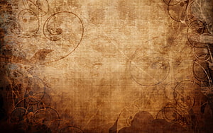 Aged parchment texture with ornate swirls and vintage sepia tones HD wallpaper