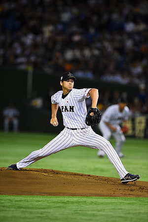 Shohei Ohtani in Los Angeles Angels pinstripe uniform mid-pitch on the mound HD phone wallpaper