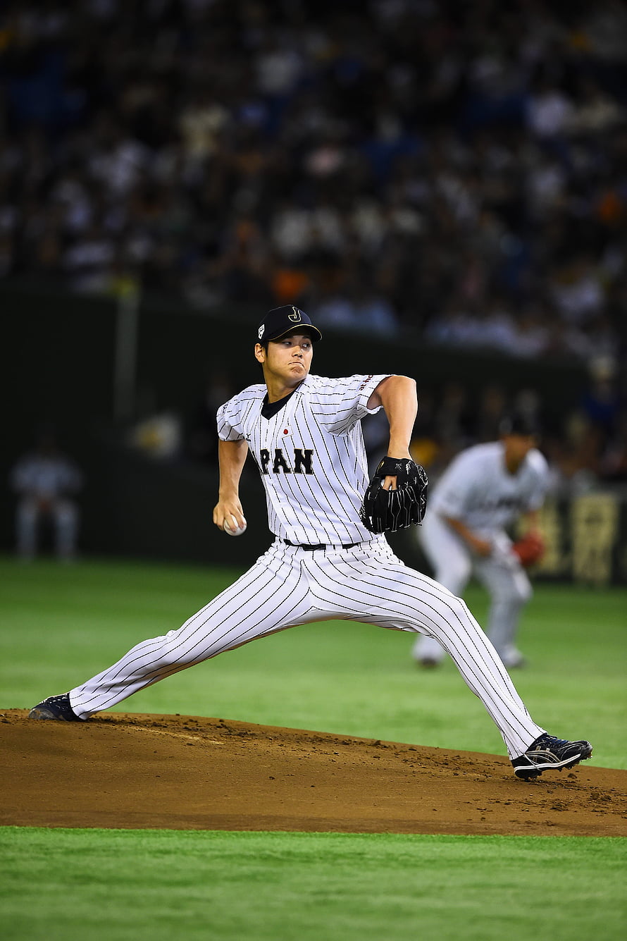 Shohei Ohtani in Los Angeles Angels pinstripe uniform mid-pitch on the mound HD phone wallpaper
