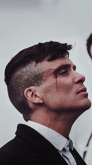 Tommy Shelby Close-Up Portrait from Peaky Blinders with Bloodied Face and Intense Gaze HD phone wallpaper
