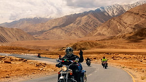 Ladakh Motorcycle Tour Through Arid Mountain Passes and Desert Valleys HD wallpaper